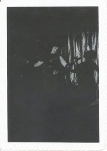 Who knows what/where she's performing? A lady performing (probably singing) on a dark stage